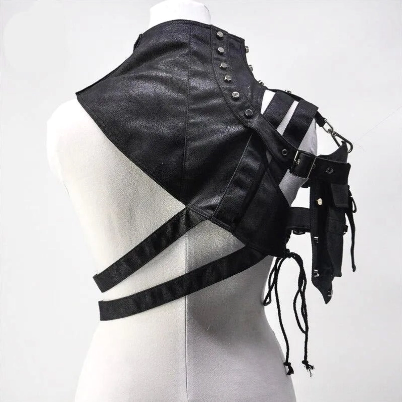 Rear view of asymmetrical one-shoulder steampunk armor showing back cross-strap configuration, metal rivets, and hanging drawstring elements on mannequin display