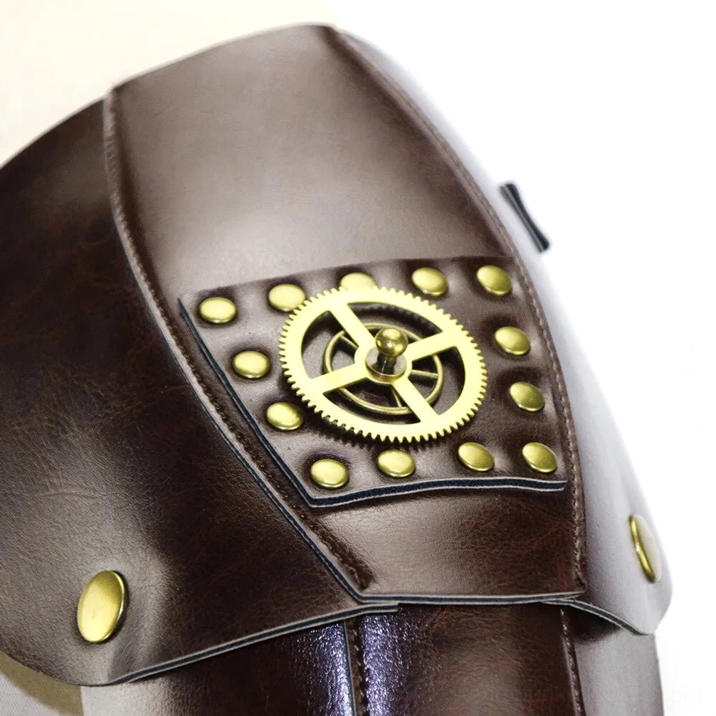 Close-up detail shot of dark brown leather steampunk armor featuring large polished brass gear emblem, round rivets, and metal stud fasteners