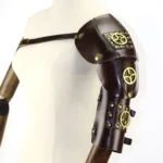 Steampunk shoulder and arm armor three-quarter left view showing brass gear emblem, rivets, and adjustable cross-body strap system on mannequin