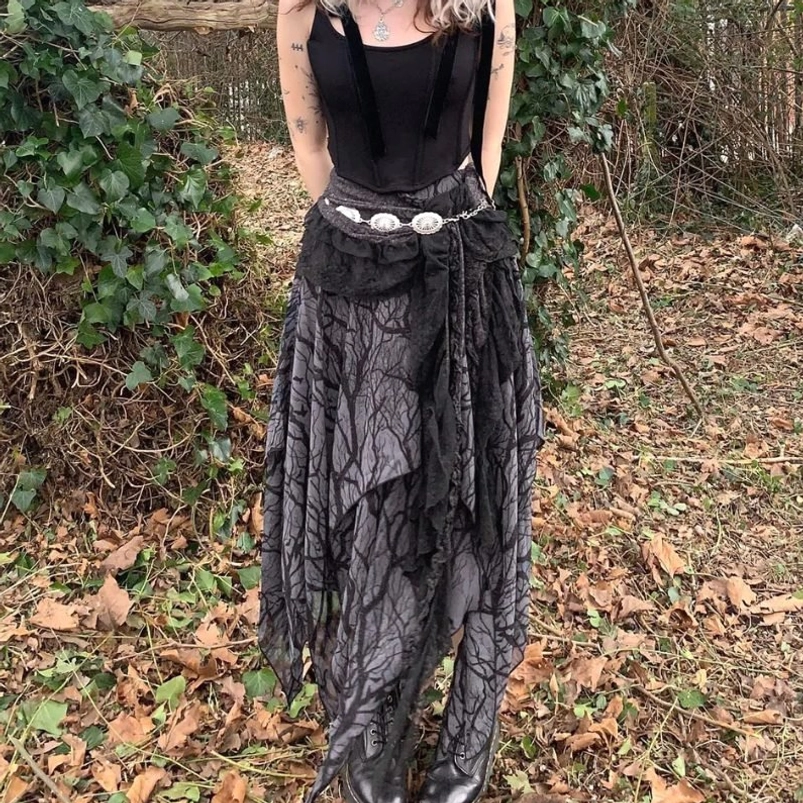 Steampunk asymmetrical midi skirt with bare branch print worn by model in outdoor woodland setting, showcasing layered lace sash and irregular hem