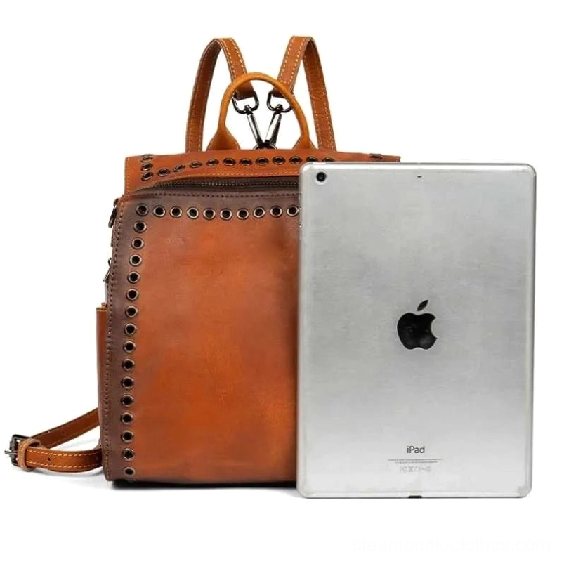 Steampunk backpack side profile view with 10-inch tablet size reference demonstrating compact yet spacious leather construction and proportional design for modern adventurers