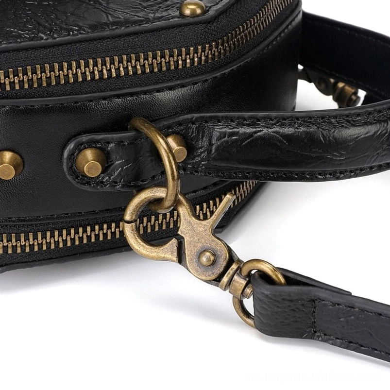 Steampunk bag hardware close-up detail featuring brass snap hooks, leather strap attachment points, metal stud fixtures, and dual brass zipper mechanisms