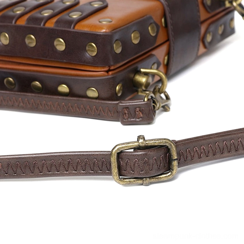 Close-up detail photograph of steampunk bag corner hardware showcasing brass rivets, double-stitched leather seams, metal embellishments and traditional craftsmanship