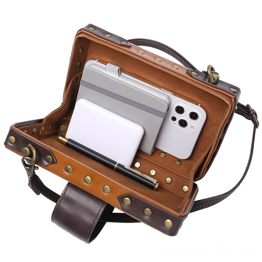 Overhead open view of steampunk leather bag interior showing organized compartments with smartphone, notebook, and pen storage - interior capacity demonstration