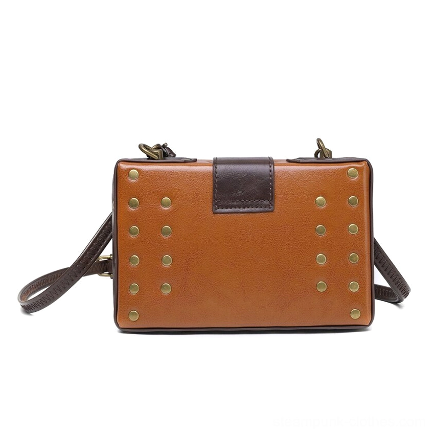 Rear side view of steampunk leather crossbody bag displaying tan vegan leather backing with symmetrically arranged brass rivets and antique hardware finish