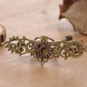 Steampunk bat wing gear ring with dual-tone bronze and copper metalwork, flat front view on wooden surface with autumn leaf styling, showcasing intricate hollowed bat silhouette and layered gear details