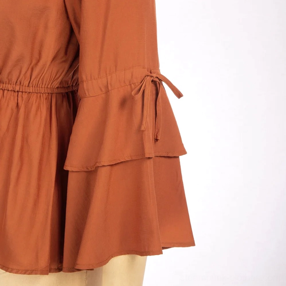 Tiered bell sleeve detail on burnt orange steampunk blouse showing layered construction