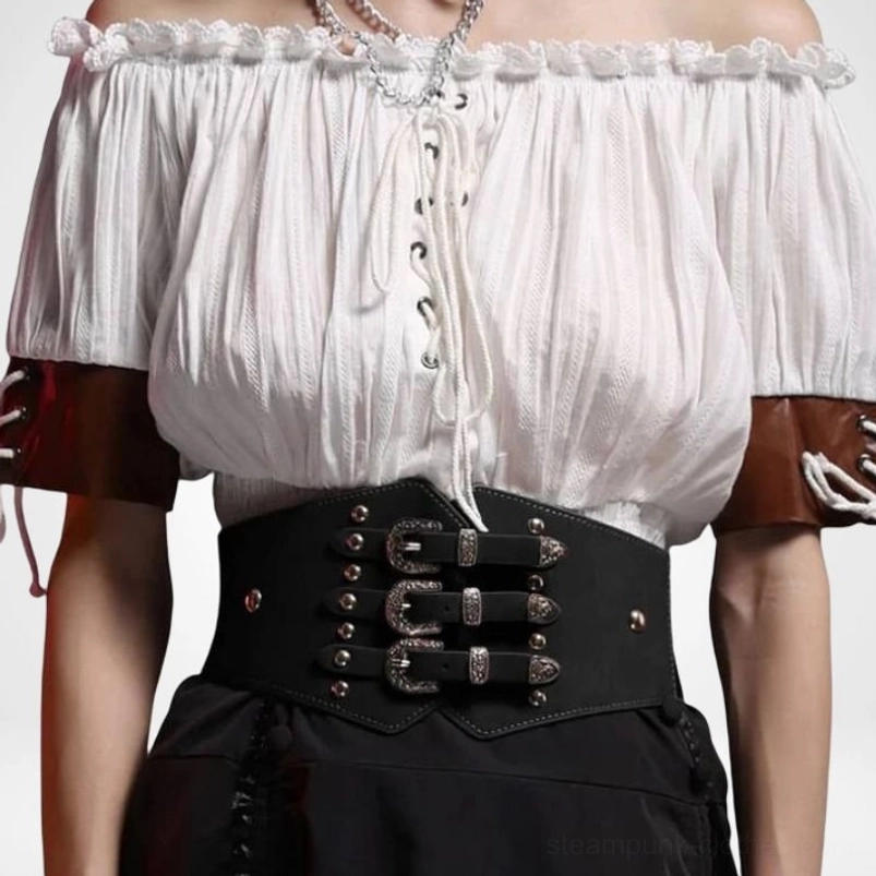 Close-up detail shot of steampunk waist belt on model torso showing triple silver engraved buckles, studs, and black PU leather texture
