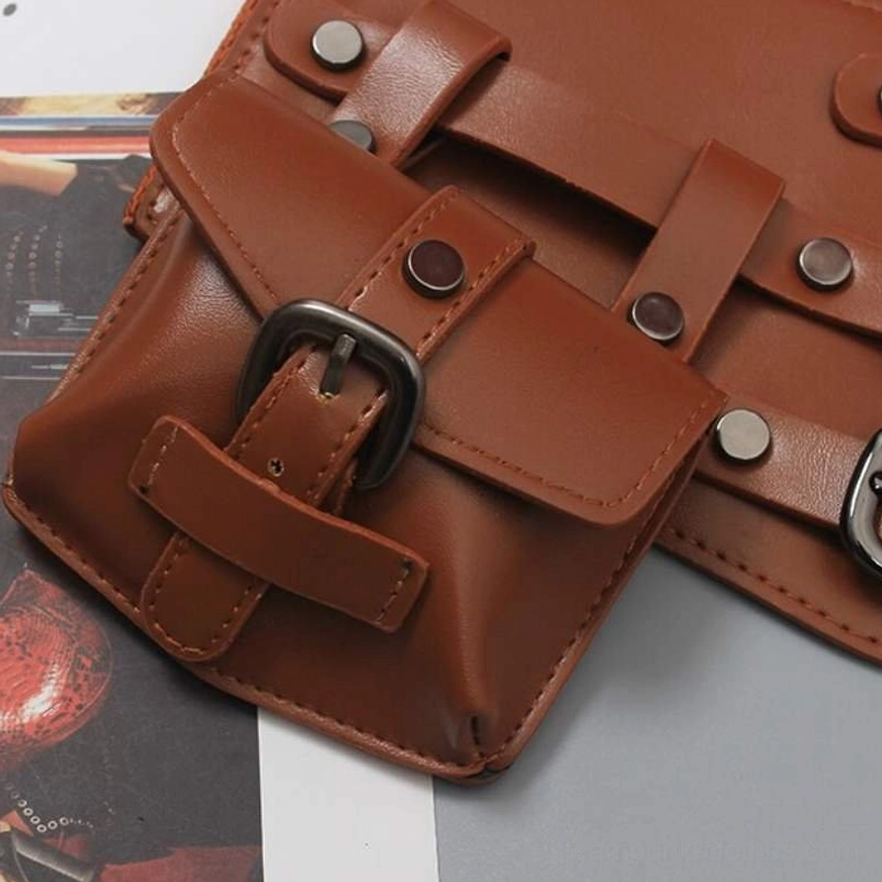 Close-up detail of steampunk belt's detachable pouch featuring buckled flap closure, metal rivet reinforcements, and faux leather matte texture on vintage printed background