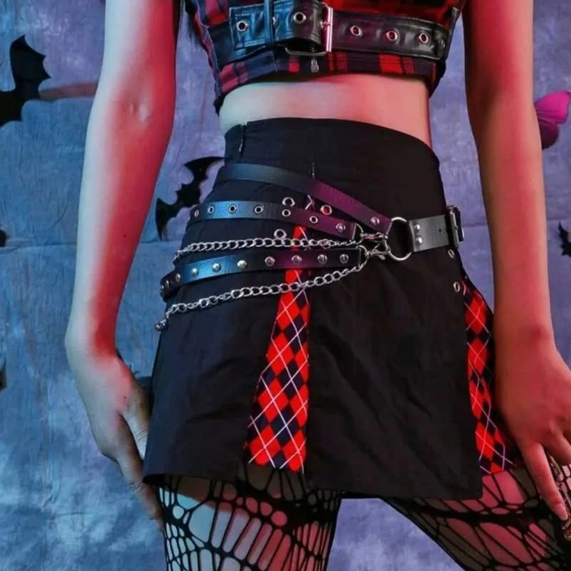 Black vegan leather steampunk chain belt with decorative silver metal chains and rivet embellishments on multi-layer straps, gothic Halloween-inspired styling on model