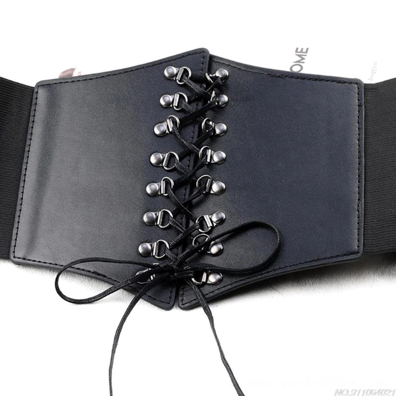 Flat lay overhead view of black laced steampunk belt displaying metal grommets and eyelets, tied lace-up ends, matte faux leather finish, and complete belt structure on white background