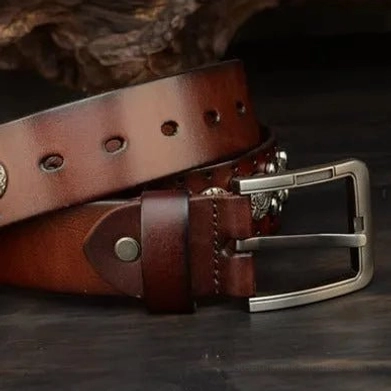 Side close-up perspective of steampunk cowboy belt revealing leather grain texture, silver-tone square metal studs, industrial rivets, and engraved buckle embellishments in vintage style