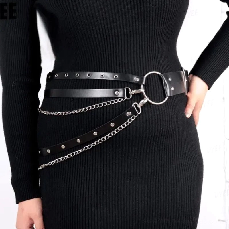 Steampunk vegan leather chain belt with silver hardware paired with black slim-fit knit dress, side profile highlighting metal chains and industrial gothic elements