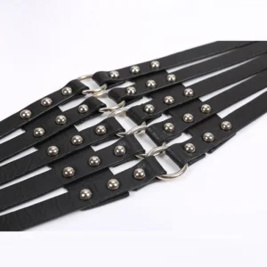 Unfastened black steampunk waist belt showing faux leather straps with silver rivets and O-ring connectors in detailed perspective, revealing internal elastic band construction