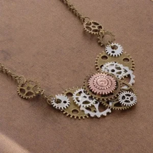 Layered steampunk cog bib necklace close-up detail view with central copper gear and multi-tonal bronze metalwork on brown fabric background