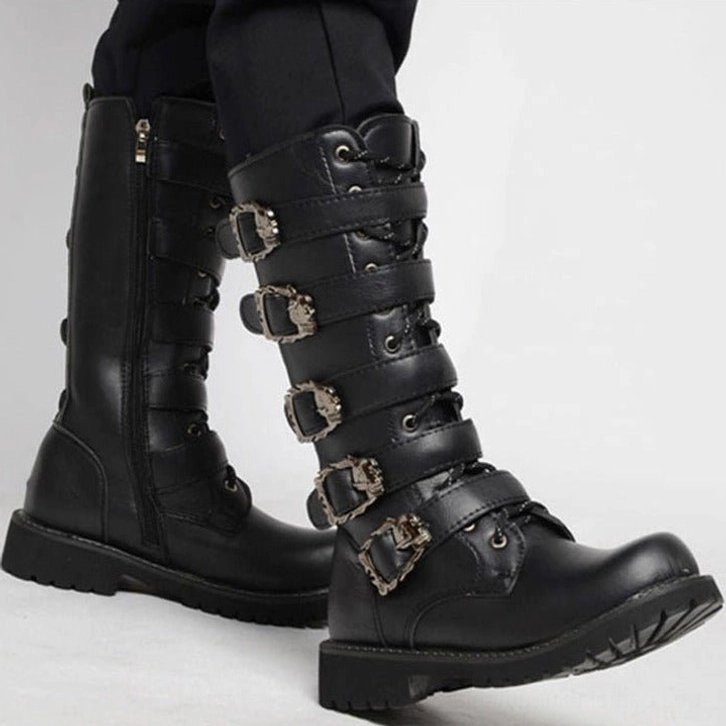 Black steampunk biker boots three-quarter side view featuring silver metal buckles, round toe, and thick lug rubber sole on white studio background