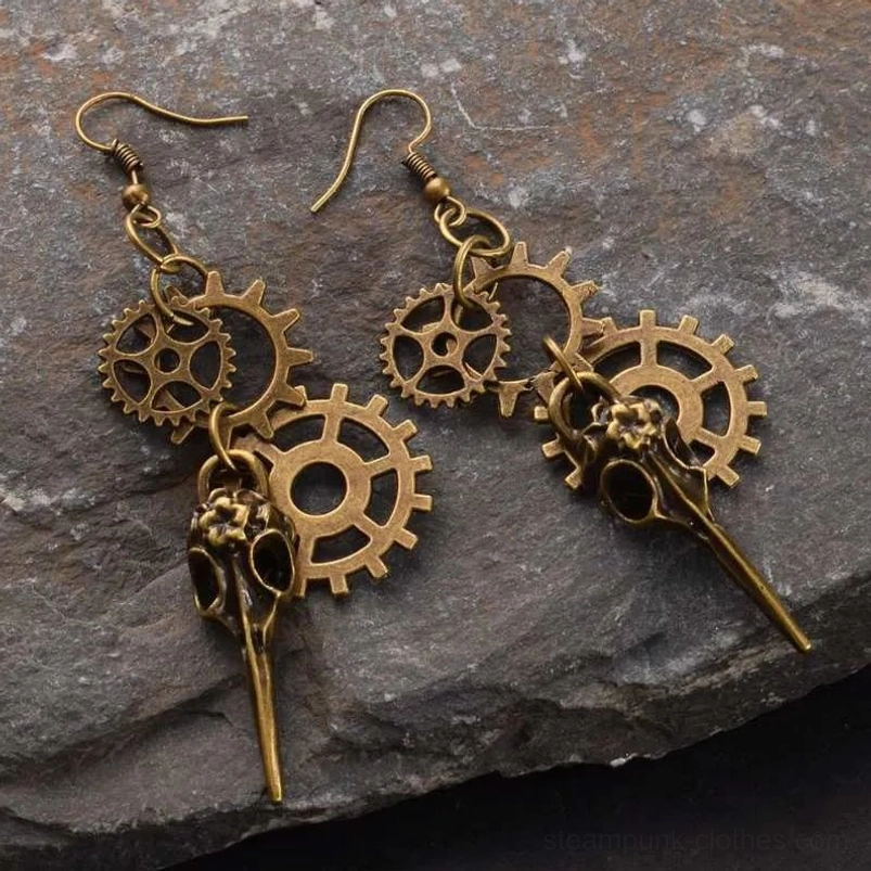 Vintage bronze bird skull gear drop earrings in Steampunk style, displayed on dark slate background with intricate mechanical details and authentic patina finish