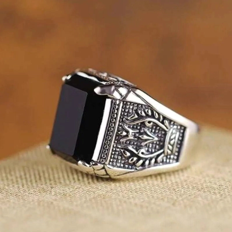 Steampunk black gem ring right side profile featuring rectangular onyx stone with ornate engraved patterns and dotted metal border