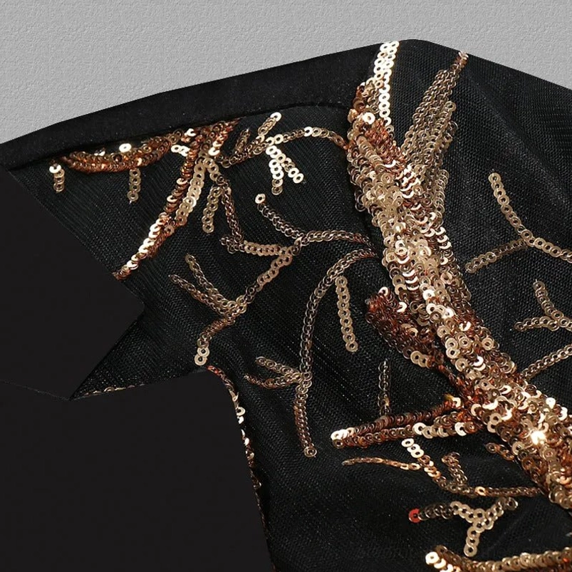 Close-up of gold sequin branch embroidery pattern on black satin lapel of steampunk jacket
