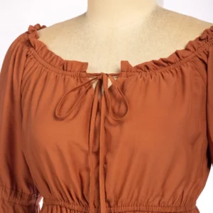 Close-up detail of ruffled neckline and adjustable lace-up tie on steampunk blouse