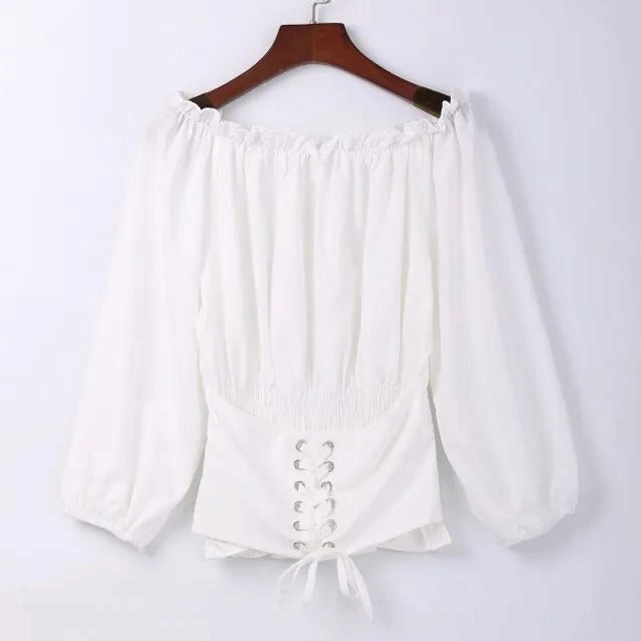 Ivory steampunk off-shoulder blouse on wooden hanger displaying front lace-up corset waist and shirred construction