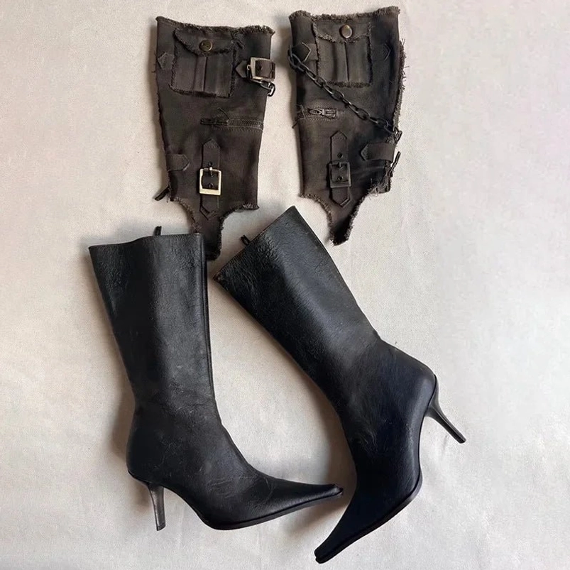 Mid-calf steampunk boots with detachable frayed canvas cuff covers, top-side view showing buckles, chains, and industrial metal accents