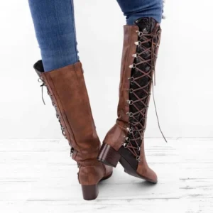 Weathered brown distressed leather steampunk boots rear close-up detail, highlighting functional metal eyelets, adjustable side lace-up system, sturdy block heel, and authentic vintage patina finish