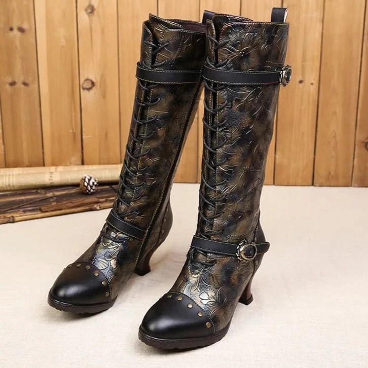 Ladies steampunk mid-calf boots with embossed leather, metal buckles, and rivets - front three-quarter view