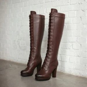 Pair of brown leather steampunk knee-high boots, full lace-up front design with brogue perforations, flat lay front view