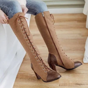 Steampunk lace-up heel boots worn on-foot with jeans, side view showing block heel and hidden zipper closure