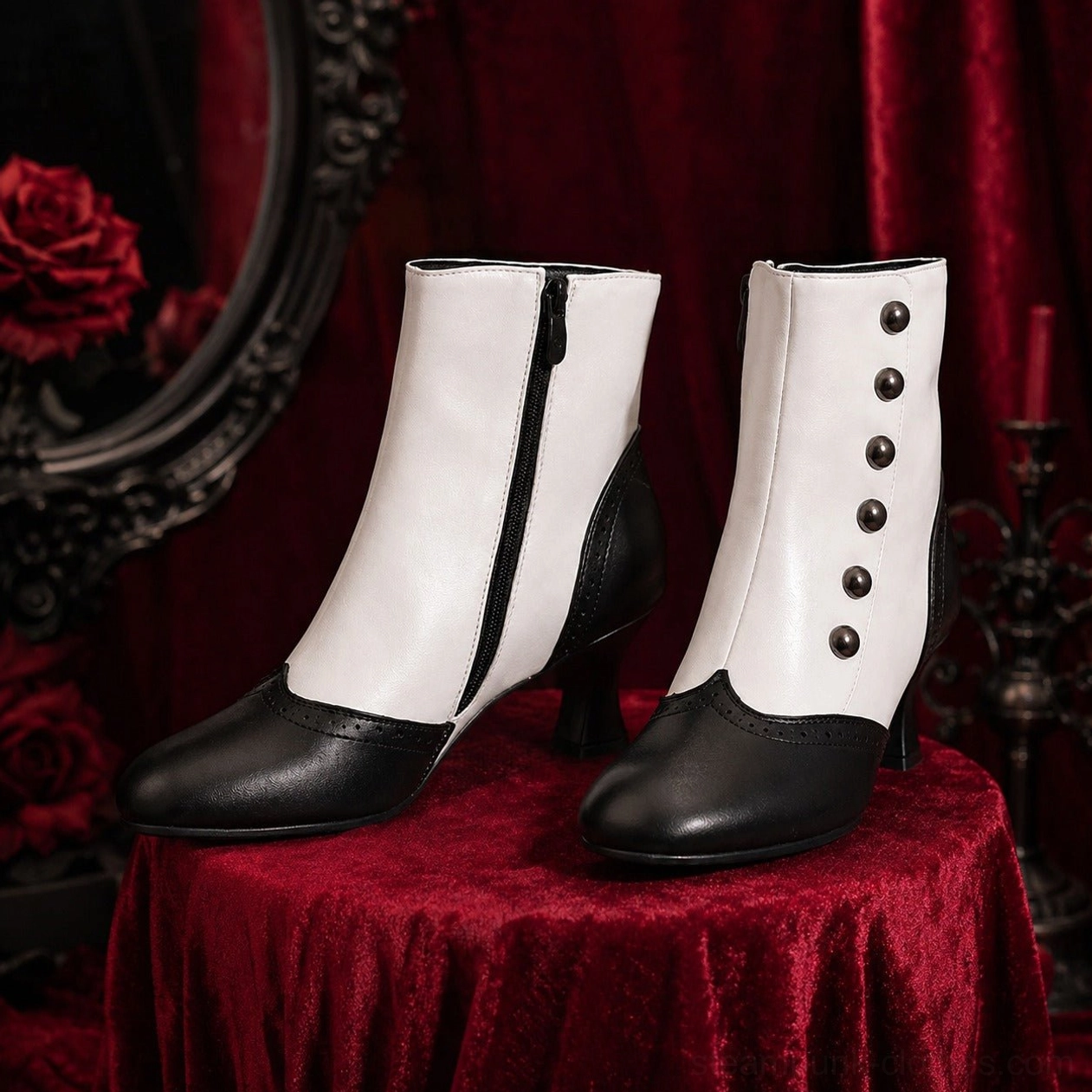 Pair of steampunk ankle boots displayed on gothic red velvet backdrop, featuring black and white leather, side zipper detail, and decorative front buttons