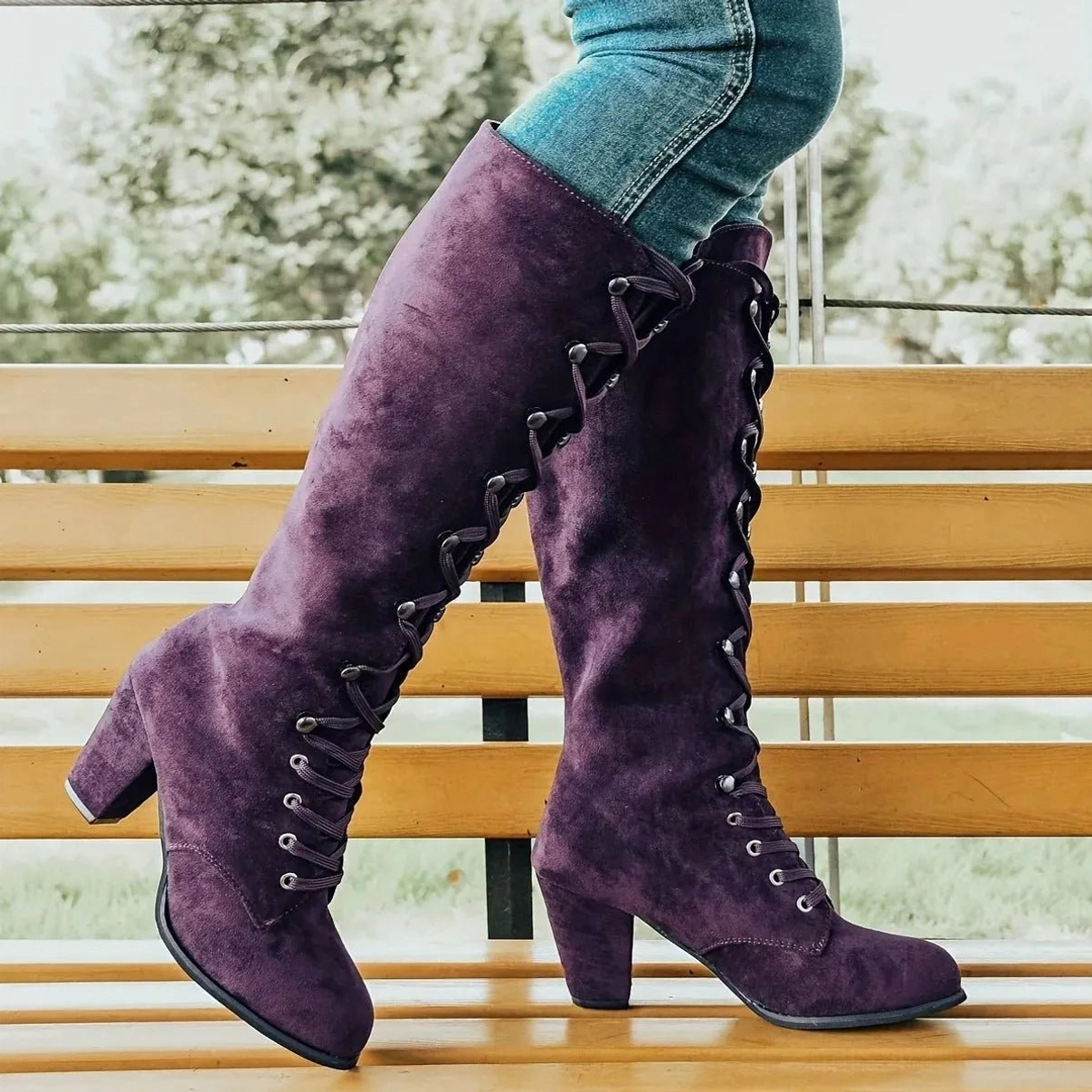 Rear side view of purple steampunk lace-up boots showing suede texture, side lace details, and square block heel structure