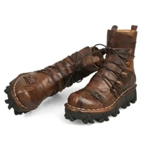 Steampunk leather boots tilted side view showcasing heel pull tabs, decorative cross straps, and hand-finished stitching details