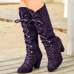 Steampunk boots side profile displaying deep purple suede material, folded cuff, metal eyelet detailing, and chunky block heel