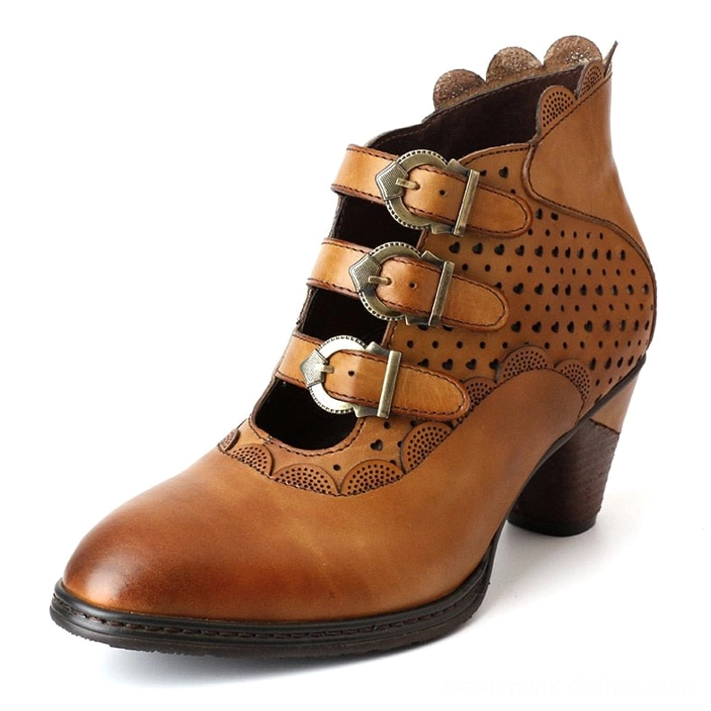 Steampunk leather ankle boot three-quarter front angle emphasizing triple metal buckle fasteners, perforated side panels, intricate cutout details, and architectural heel design