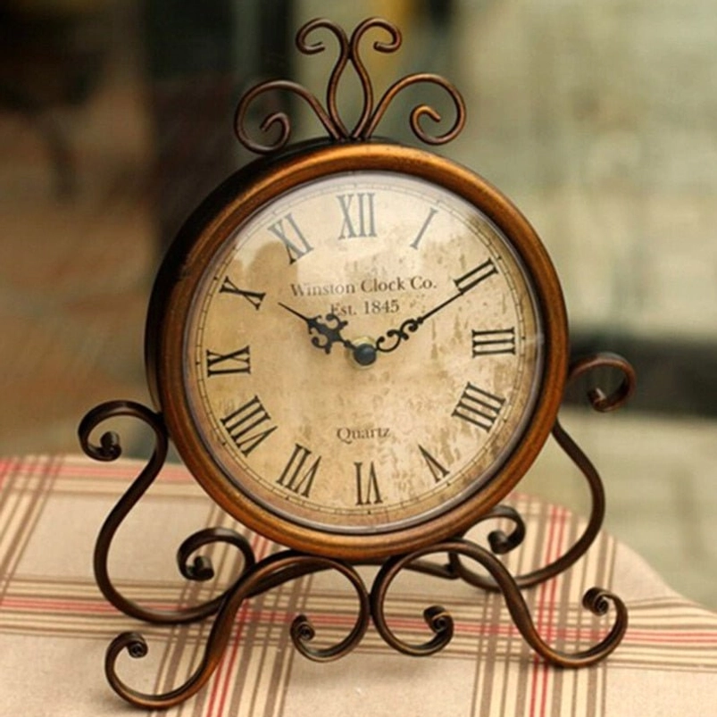 Steampunk bronze desk clock with wrought iron frame and Roman numeral dial, frontal view on plaid cloth backdrop