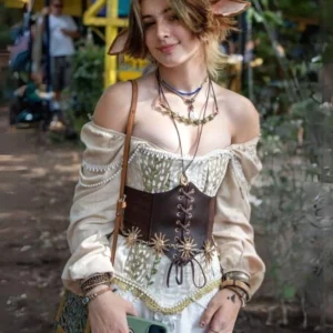 Steampunk brown leather underbust corset belt with layered gold sun chain motifs and precision lace-up front closure, styled at outdoor alternative fashion market showcasing authentic Victorian-industrial fusion