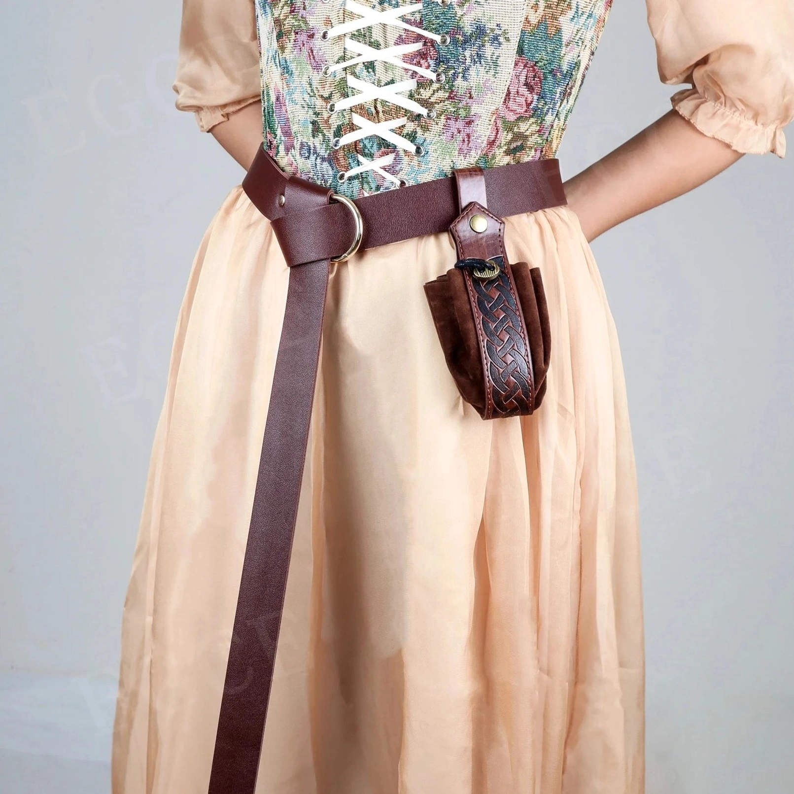 Steampunk women's brown leather belt with intricately woven Celtic knot pouch, side profile showcasing D-ring hardware, decorative leather cords, and metal snap fastener detail