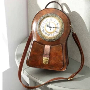 Steampunk clock crossbody bag in distressed brown genuine leather featuring functional Roman numeral clock face, brass hardware, and front three-quarter display view on table