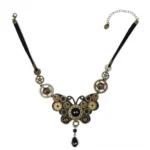 Steampunk butterfly choker necklace flat lay display showing black leather band with vintage brass gears, aged bronze accents, and black teardrop pendant with 10cm extension chain on white background