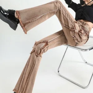 Distressed frayed denim pants side angle sitting pose showing knee patch details and platform loafers steampunk fashion