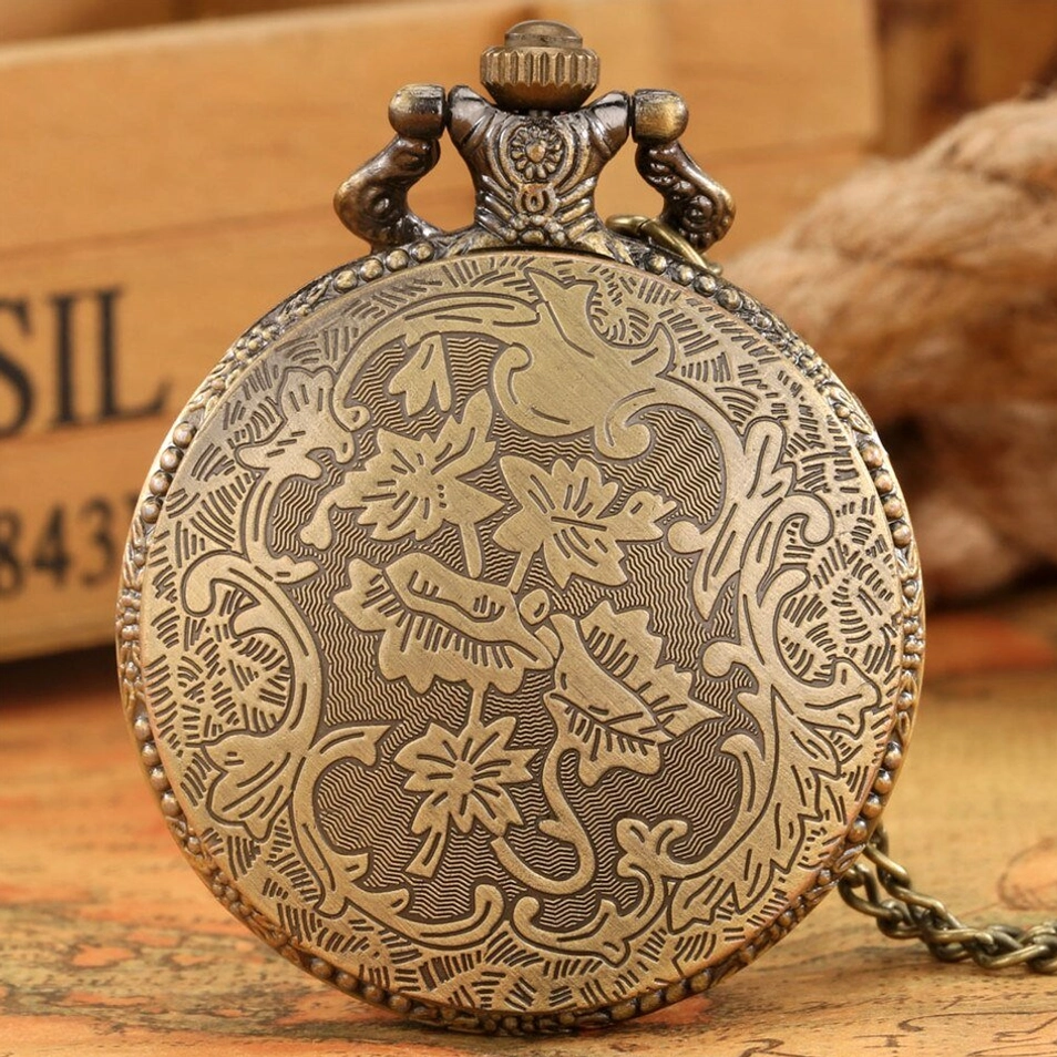 Back case of steampunk butterfly pocket watch with full ornate engraving of floral and bird patterns, bronze finish with decorative pendant top
