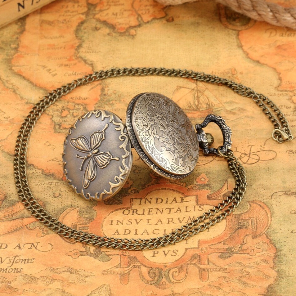 Steampunk butterfly pocket watch with included twisted bronze chain in flat lay, showing dual decorative surfaces and vintage metal material