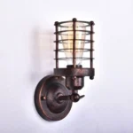 Steampunk cage wall lamp left side view with rustic bronze metal finish and horizontal metal guard frame on white wall