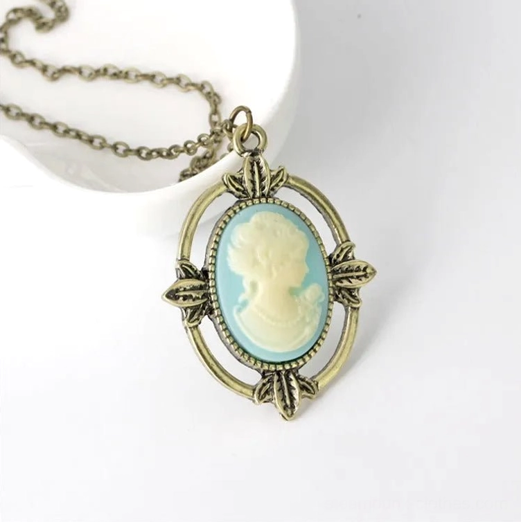 Steampunk cameo pendant necklace frontal view showing blue cream profile and bronze frame