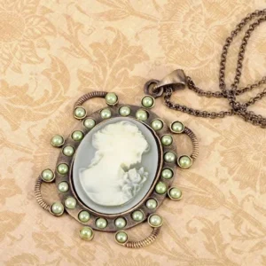 Steampunk cameo pendant necklace featuring antiqued bronze frame with green faux pearl border, displaying classical female profile on vintage floral damask background