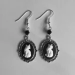 steampunk gothic cat cameo drop earrings with ornate silver filigree frame and black-white cat profile on light background