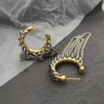 Dual-tone chain tassel hoop earrings featuring gold-tone frames and silver woven curb chain tassels in steampunk style