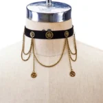 Black velvet steampunk choker with antique bronze gear charms and layered chain pendants featuring central retro medallion - front flat lay on dress form mannequin