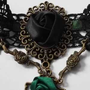 Close-up detail of steampunk choker central pendant featuring bronze filigree frame and black satin rose flower